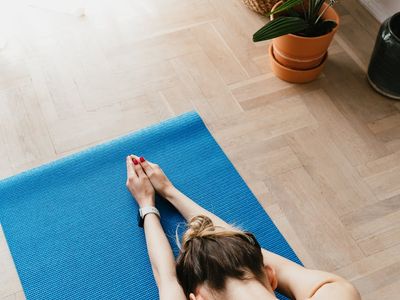 A comfortable yoga mat rolled out in a peaceful room.