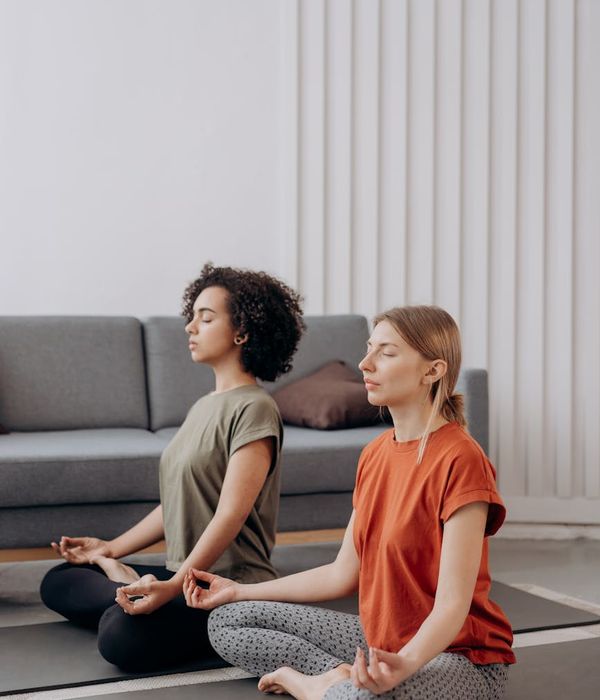 Woman practicing yoga in a spacious, light-filled room.